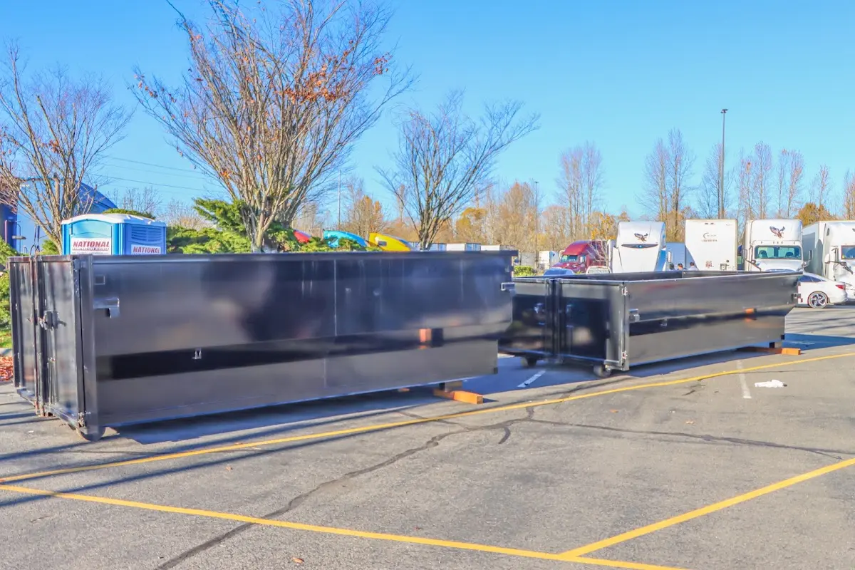 Professional dumpster rental service with roll-off container on residential driveway in Hillcrest Heights